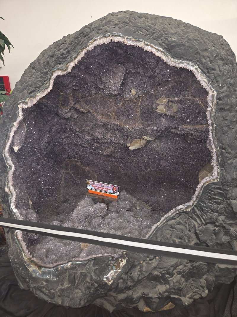 Massive amethyst geode cathedral with dark purple crystals and white quartz banding