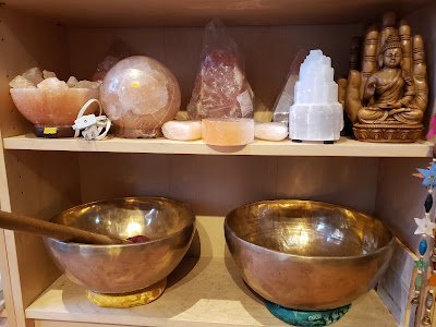 Variety of gemstones, crystal carvings, and polished mineral specimens