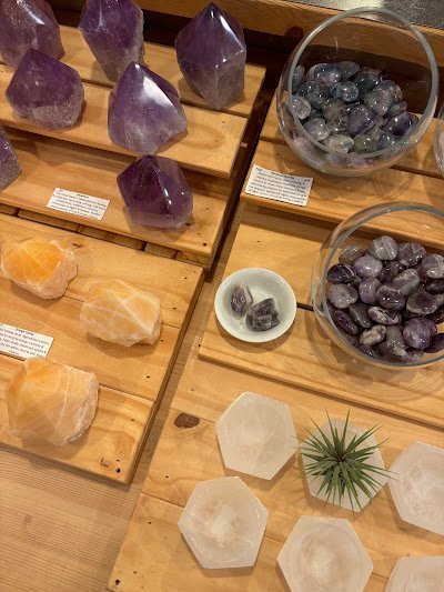 Crystal specimens and minerals displayed with spiritual and metaphysical items