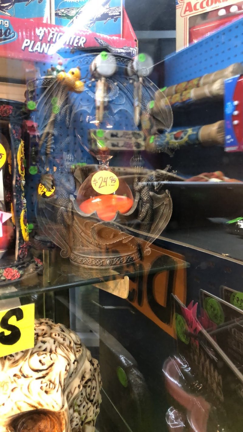 Dragon statue incense burner display with decorative smoke accessories and pricing