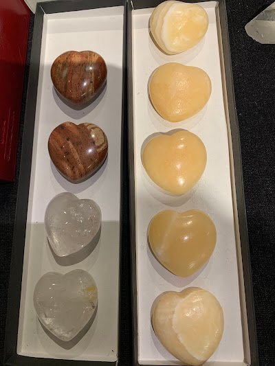 Collection of tumbled stones, raw minerals, and crystal clusters