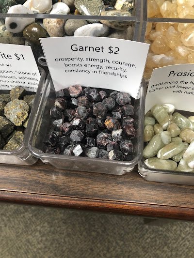 Shelving featuring chakra stones, healing crystals, and mineral specimens