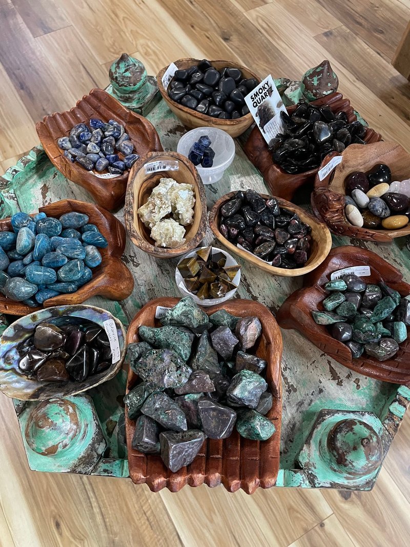 Selection of healing crystals, tumbled stones, and decorative mineral pieces