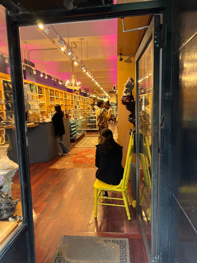 Retail shelving with organized crystals, stones, and spiritual products