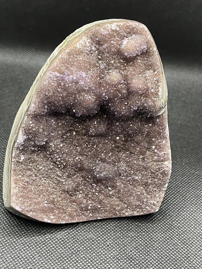 Display of crystal jewelry, tumbled stones, and carved gemstone pieces