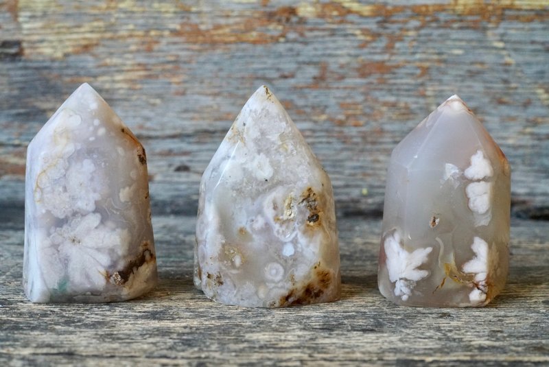 Variety of gemstones, crystal carvings, and polished mineral specimens