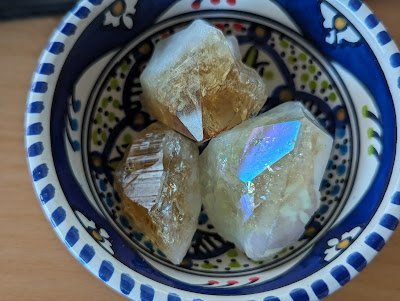 Shelving display featuring amethyst, quartz, and various crystal specimens
