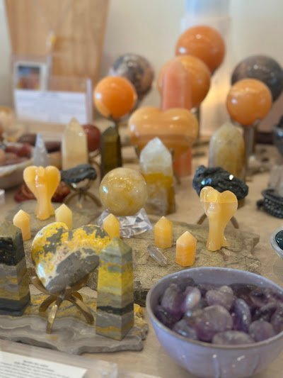 Retail shelving with organized crystals, stones, and spiritual products