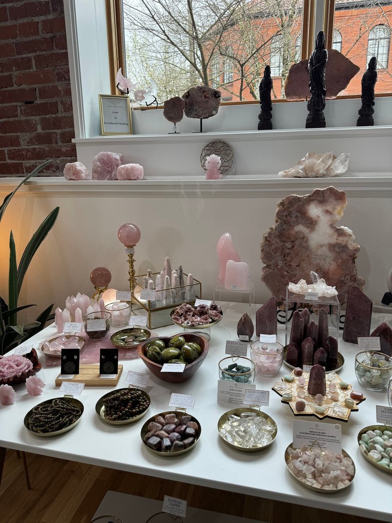 Display featuring crystal points, polished stones, and raw mineral specimens
