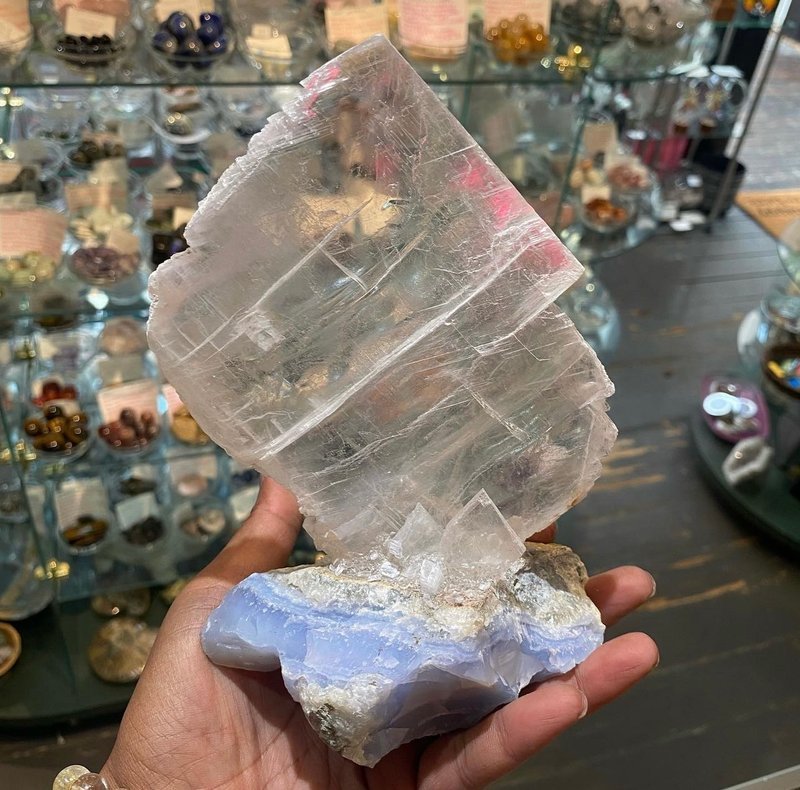 Display featuring crystal points, polished stones, and raw mineral specimens