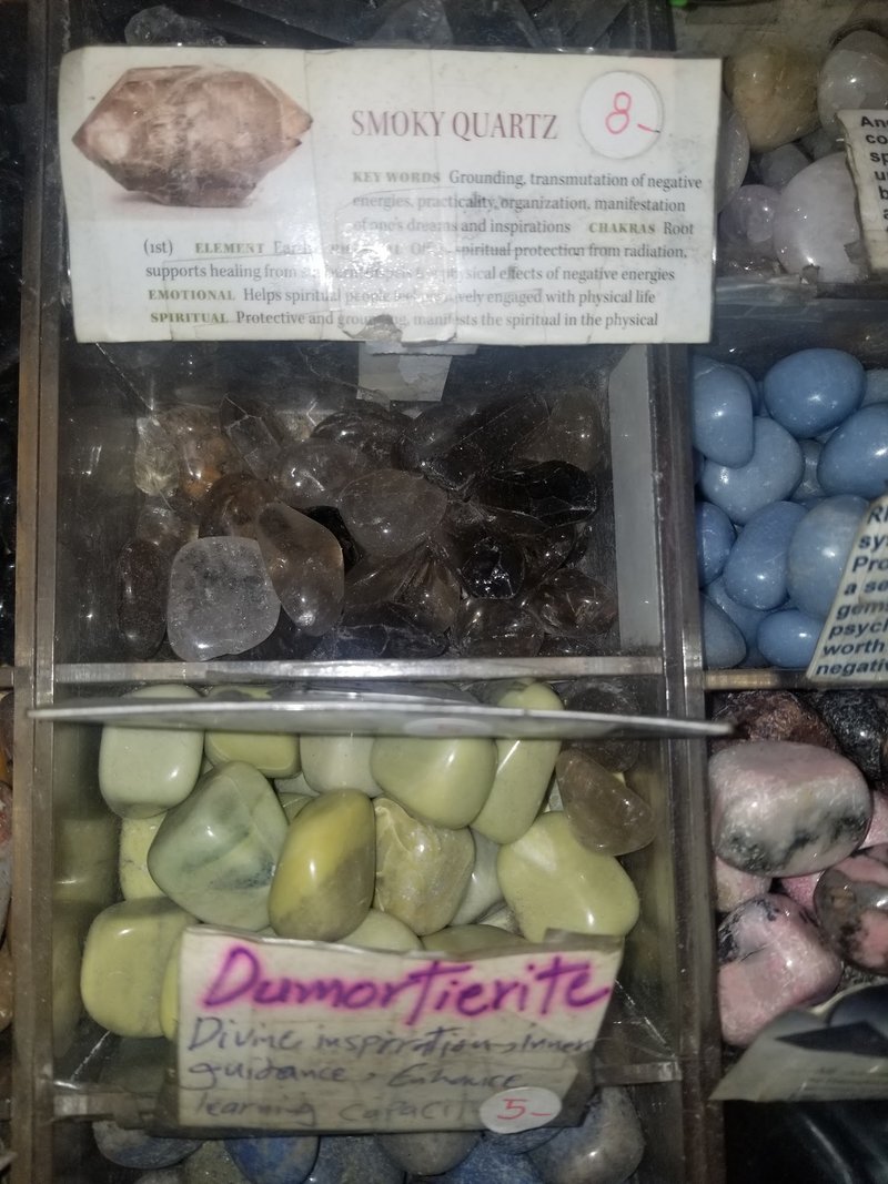 Display featuring crystal points, polished stones, and raw mineral specimens