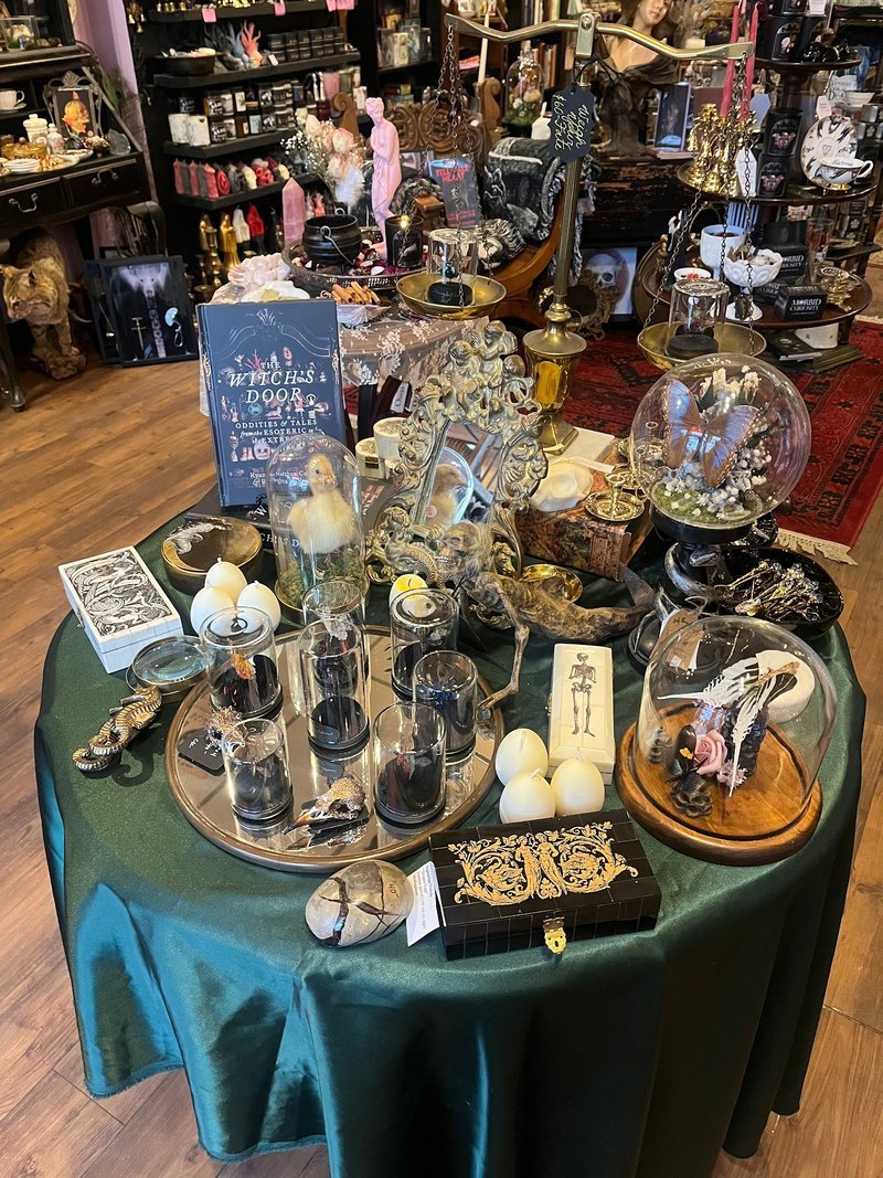 Shelving display featuring amethyst, quartz, and various crystal specimens