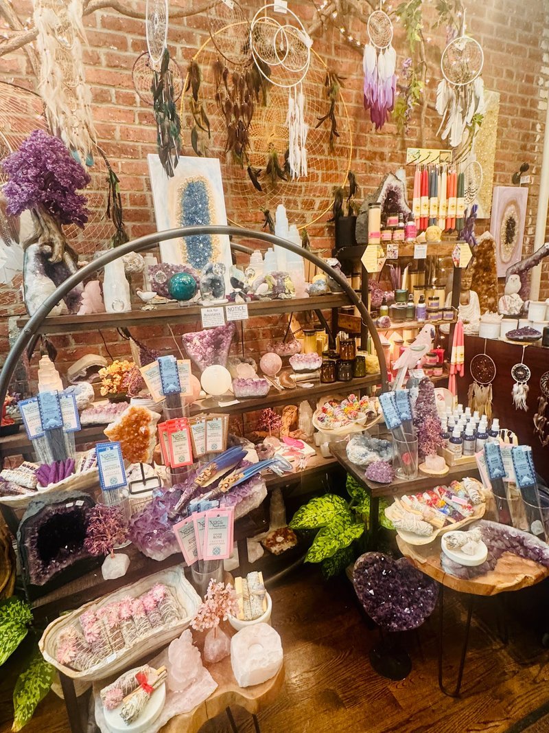 Retail shelving with organized crystals, stones, and spiritual products
