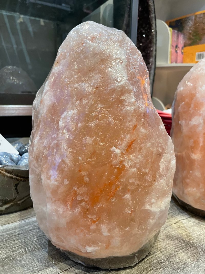 Retail shelving with organized crystals, stones, and spiritual products