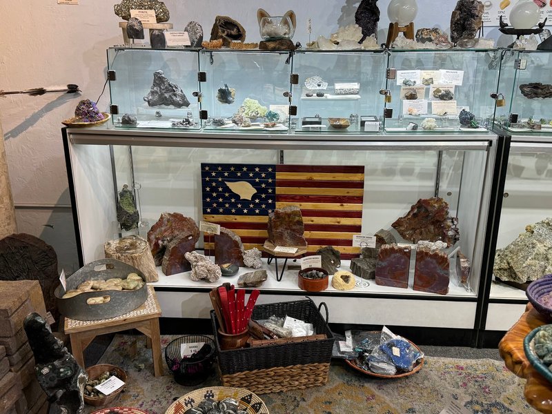 Display featuring crystal points, polished stones, and raw mineral specimens