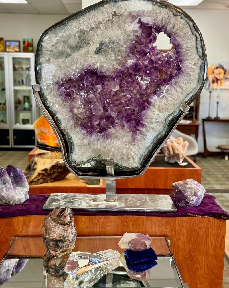 Variety of gemstones, crystal carvings, and polished mineral specimens