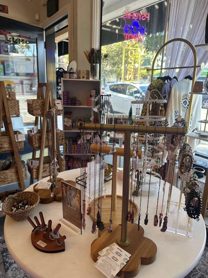 Display featuring crystal points, polished stones, and raw mineral specimens