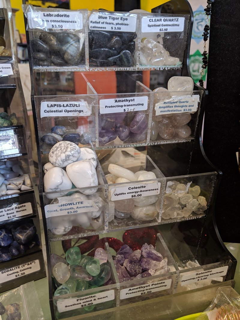 Organized crystal display with labeled stones and healing minerals