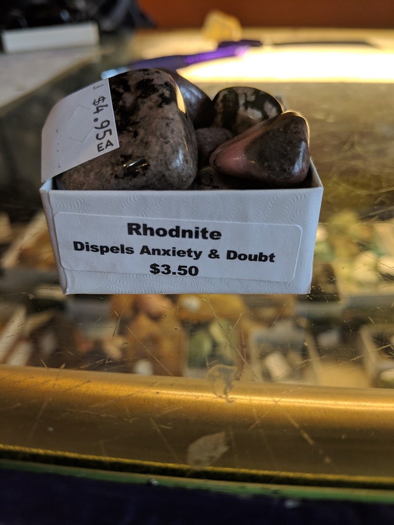 Variety of gemstones, crystal carvings, and polished mineral specimens