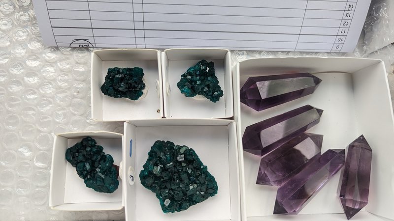 Crystal and mineral specimens including quartz, amethyst, and calcite varieties