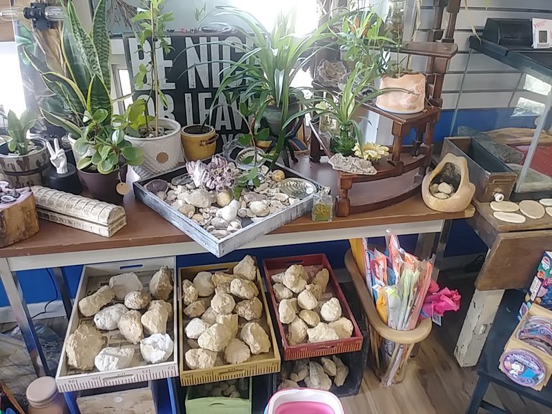 Shelving display featuring amethyst, quartz, and various crystal specimens