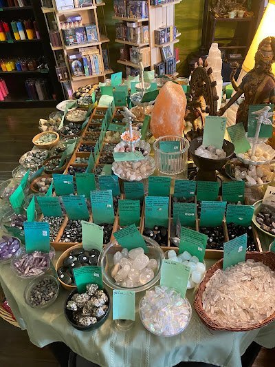Crystal specimens and minerals displayed with spiritual and metaphysical items
