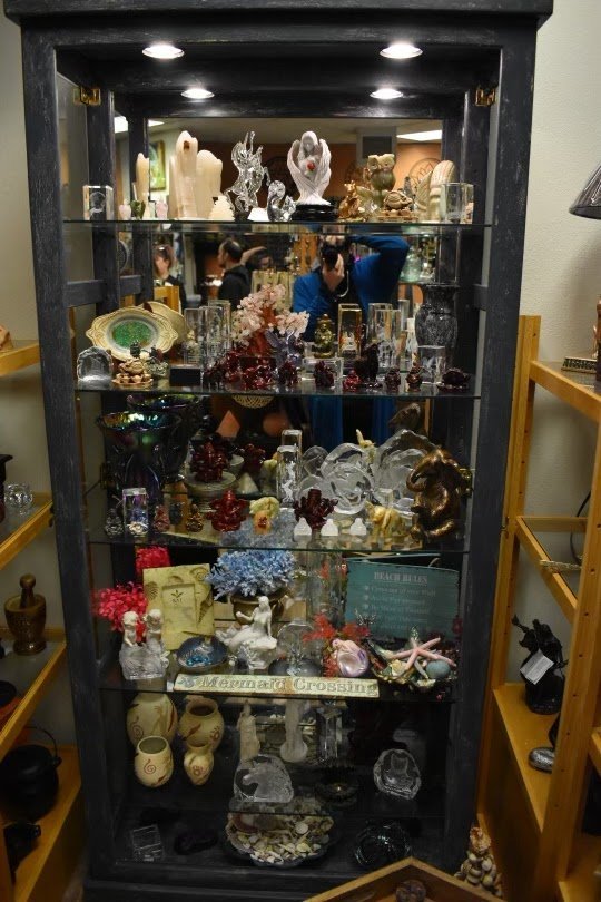 Variety of gemstones, crystal carvings, and polished mineral specimens