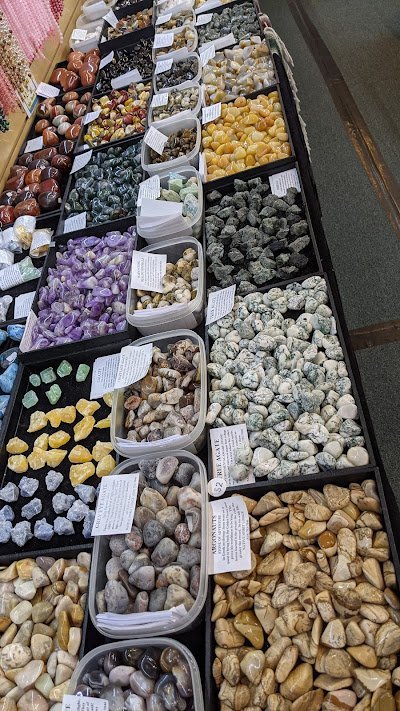 Retail shelving with organized crystals, stones, and spiritual products