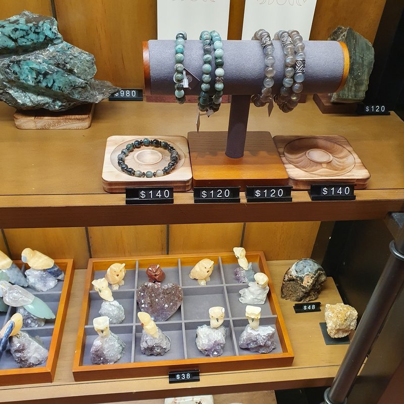 Display of polished crystal specimens, geodes, and mineral towers