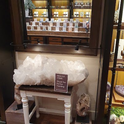 Display featuring crystal points, polished stones, and raw mineral specimens