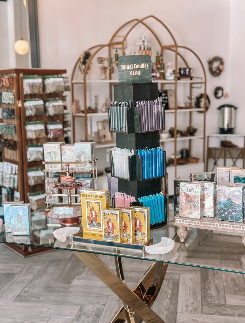 Shelving display featuring amethyst, quartz, and various crystal specimens