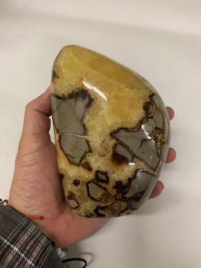 Variety of gemstones, crystal carvings, and polished mineral specimens