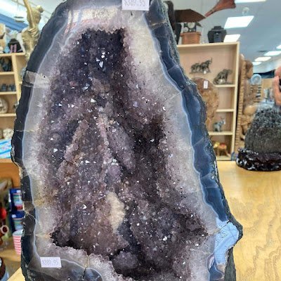 Retail shelving with organized crystals, stones, and spiritual products