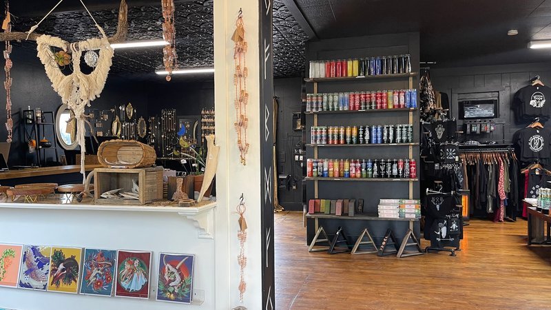 Store interior with colorful candle display wall and metaphysical supplies